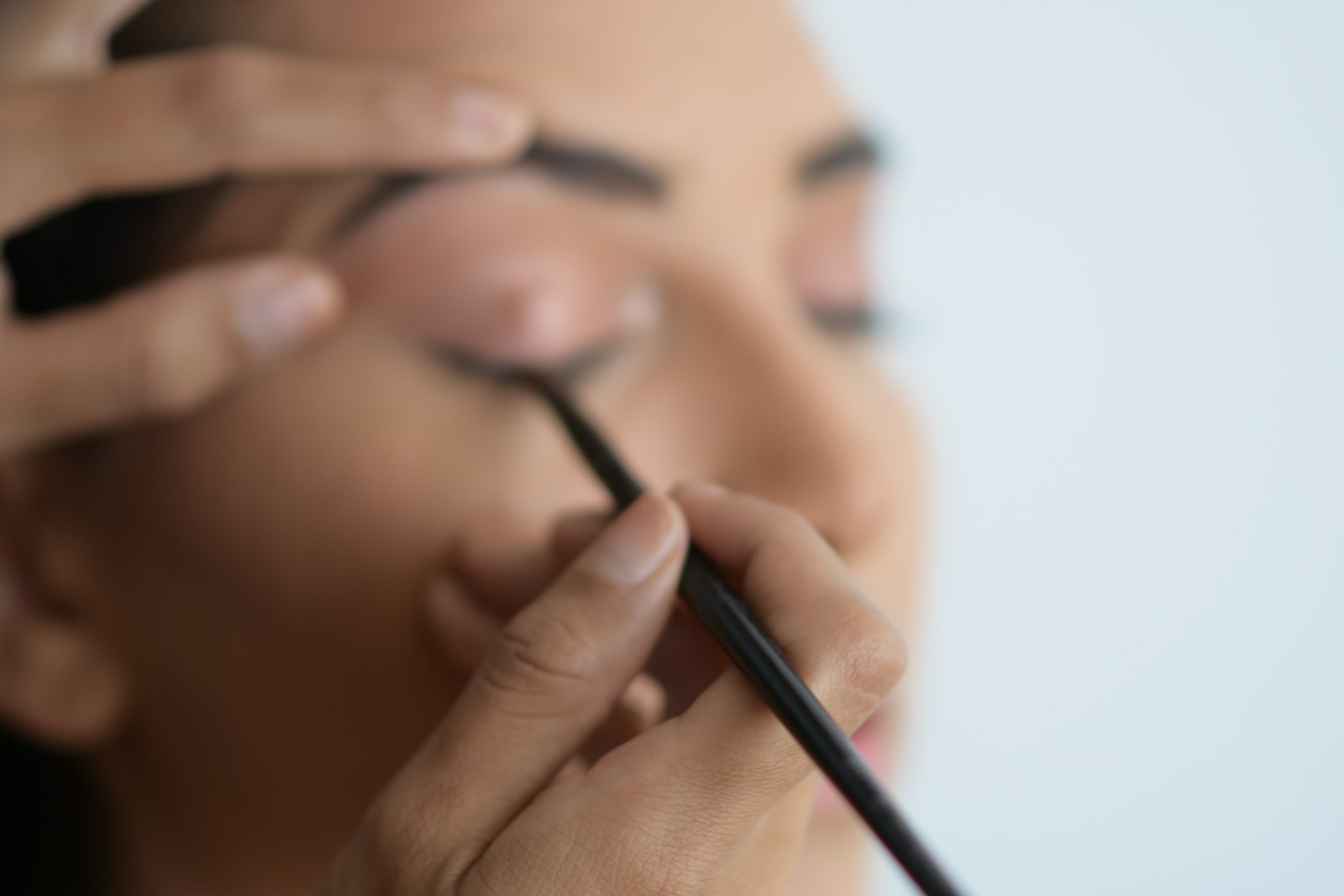 person holding black pen in close up photography