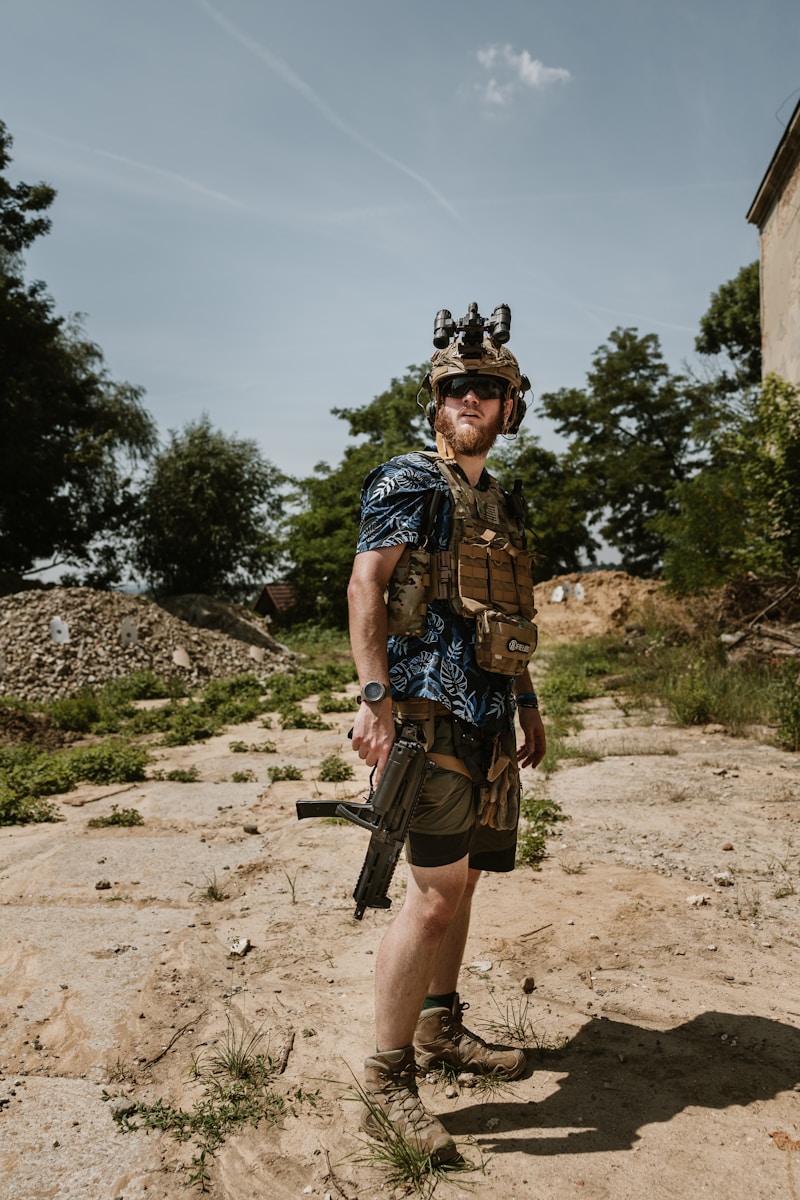 A man wearing a helmet and holding a rifle