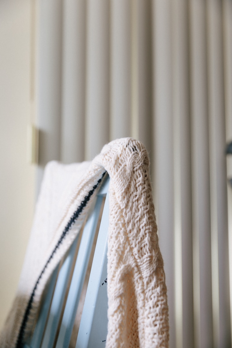 white textile on white window blinds